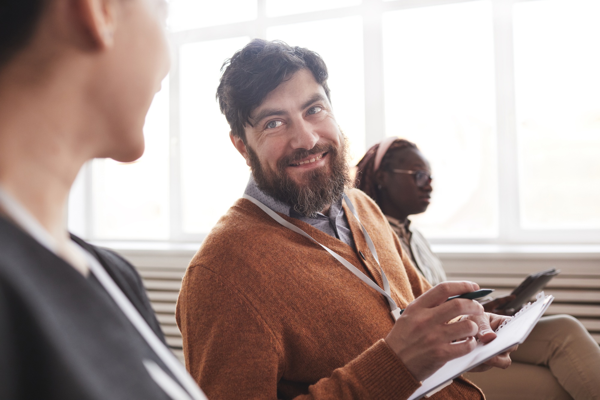 Smiling Bearded Man at Business Conference